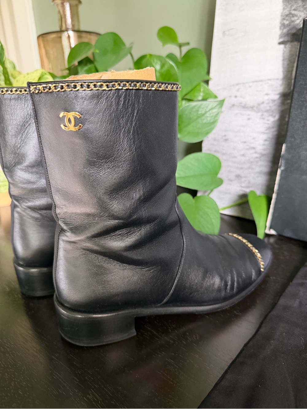CHANEL Black Leather Mid-Calf Boots with Gold Chain Accent